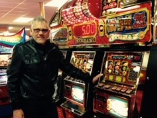 Neville Infront of two slot machines in las vegas