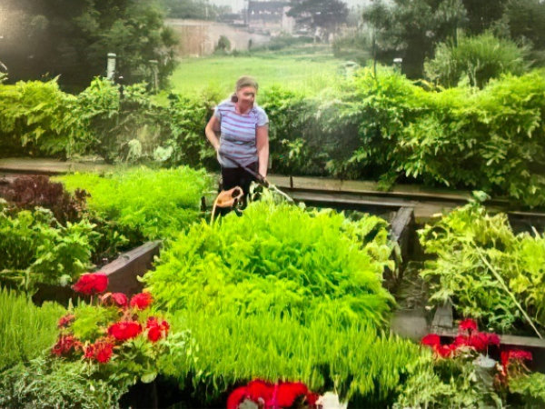 Marilyn working in her garden