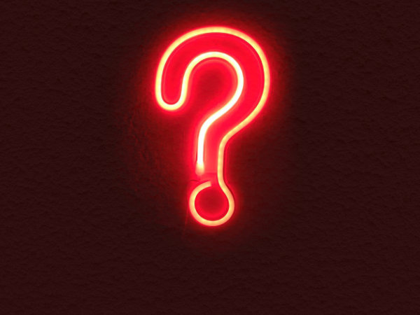 Red Neon question mark on black wall