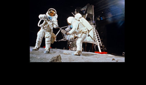 Astronaut in studio with moon lander in the background
