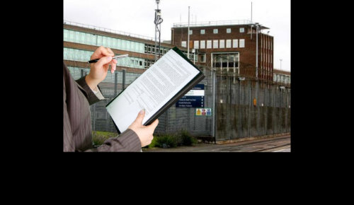 Man with clipboard Infront of the back on England