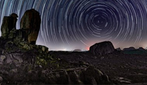 Long exposure photo of Polaris with rocks in the foreground