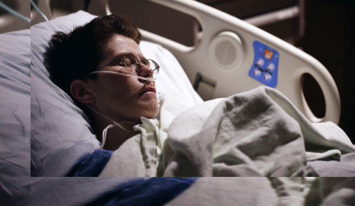 Patient ill in bed with oxygen tube