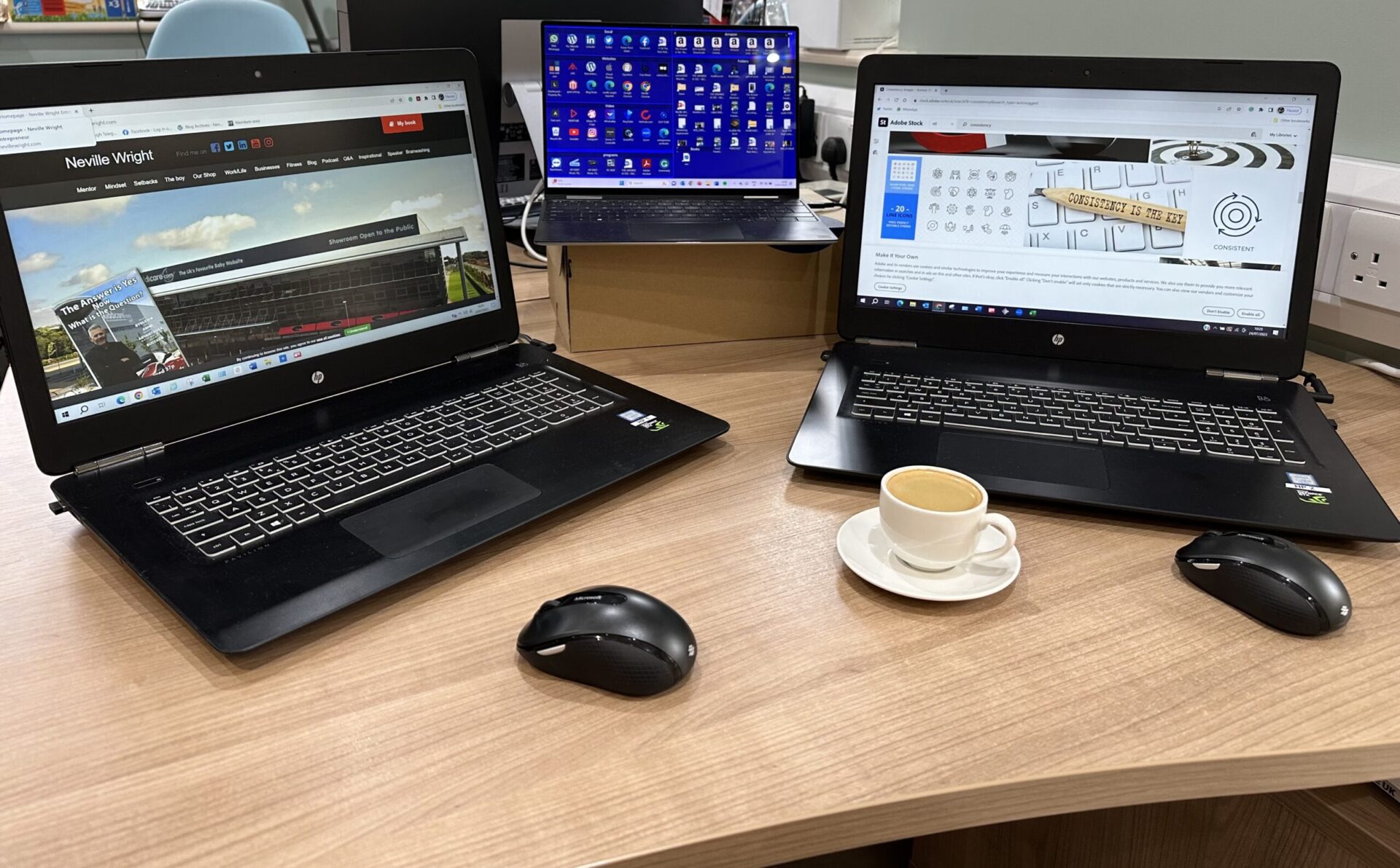 Tidy Desk with 3 laptops and a cup of coffee